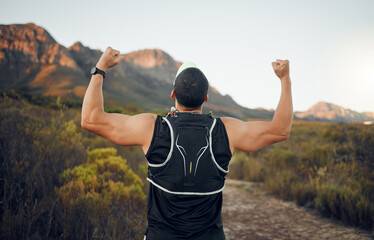 Fototapeta premium Winner, mountain and runner man success with back view celebrating cardio exercise goal victory. Muscular, strong and fitness lifestyle male running achievement celebration in South African bush.
