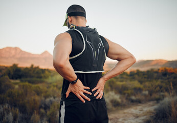 Muscle, injury and back pain after a workout or running outdoor. Man holding lower back muscles in...