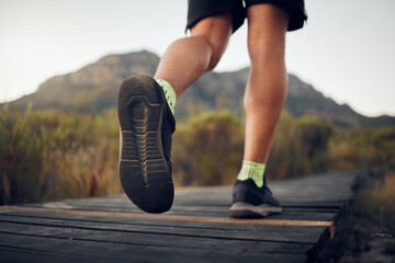 Man, hiking and shoes with legs on mountain for run, workout or fitness. Nature, wellness and...