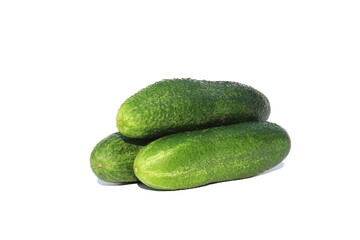 A bunch of fresh cucumbers lie on an isolated white background.
