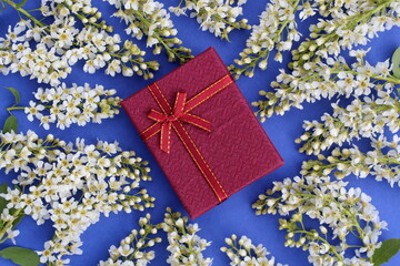 The gift box lies on a cherry blossom.