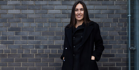 stylish confident woman lawyer against brick wall background