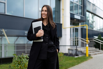 portrait of a strong successful female leader against the backdrop of a modern office