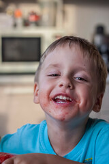 Cute boy eating watermelon at home. Real emotions without posing.