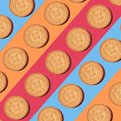 Pattern of cookies. Cookies on multi-colored background. Festive, children's background. Flat lay. Sweet cookies flat lay pattern on light pink background. Top view.