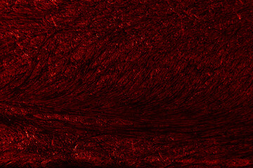 Crimson colored background with wavy textures of different shades of dark red