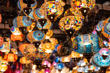 Colorful hanging lights from turkey on display for sale in Diwali fair to brighten the rooms. Artistic selective focus background.