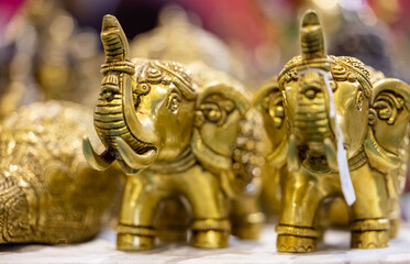 Elephant idol made of brass with blur background. Selective focus on elephant idol.