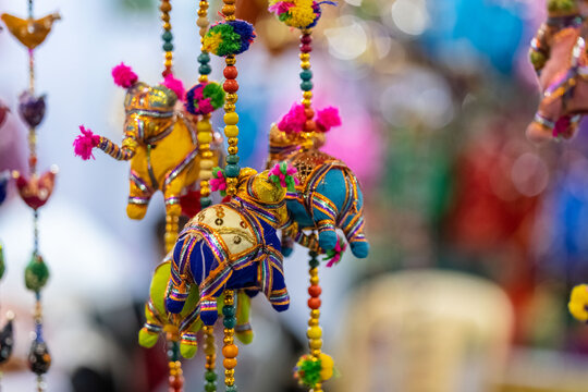 Handmade colorful Puppets or kathputli hanging with blur background. Selective focus on puppet.