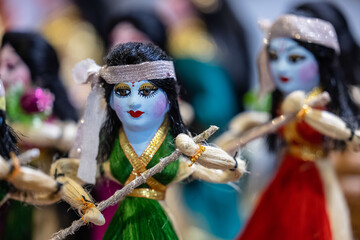 Handmade colorful Puppets or kathputli hanging with blur background. Selective focus on puppet. 