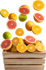 Oranges and tangerines falling on a wooden box