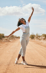 Freedom, nature and travel with a black woman on a sand road in the dessert during a summer...