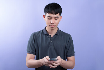 Handsome businessman shooting a photos in studios. On the purple background.