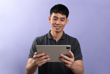 Handsome businessman shooting a photos in studios. On the purple background.