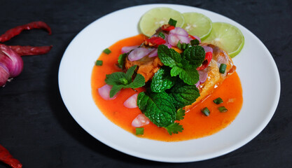 Canned fish salad on a dark background. Select focus.