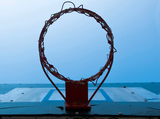 Fototapeta na wymiar The old basketball hoop against the blue sky