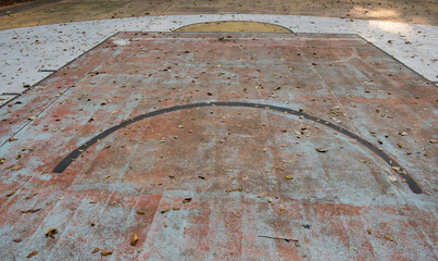 Old basketball court and leaves on the floor