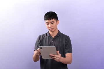 Handsome businessman shooting a photos in studios. On the purple background.