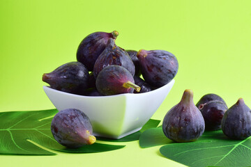 Fruit, figs in white porcelain bowl and scattered.