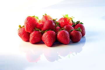 Fresh, red and delicious strawberries on a light background