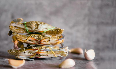 Close-up shot of fresh blue crab isolated on background, sea crab. Seafood. Seafood and spices concept. Garlic.