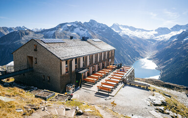 Breathtaking panoramic view on the Olperer mountain hut. Valley with Schlegeis reservoir at the...
