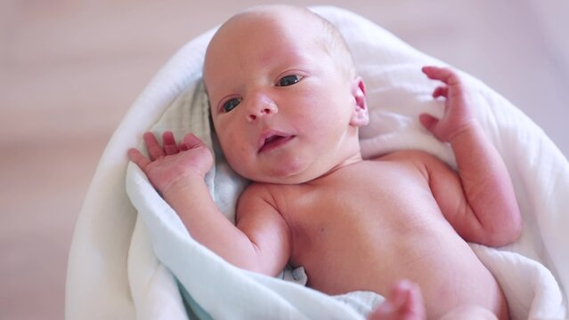 newborn. baby newborn close-up lies looking at the camera in the hospital maternity hospital. happy family baby dream concept. cute newborn baby wrapped in a blanket lifestyle
