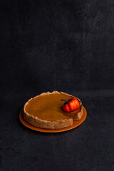 traditional pumpkin pie on black background, american recipe, jellied pie with condensed milk and cinnamon, october, autumn dish, homemade cake, thanksgiving, harvest, cozy, space for text, postcard