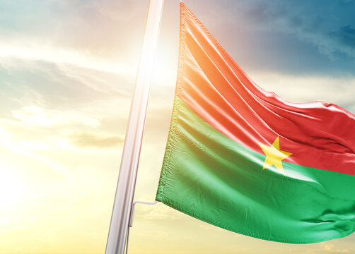 Burkina Faso national flag cloth fabric waving on the beautiful sunlight - Image