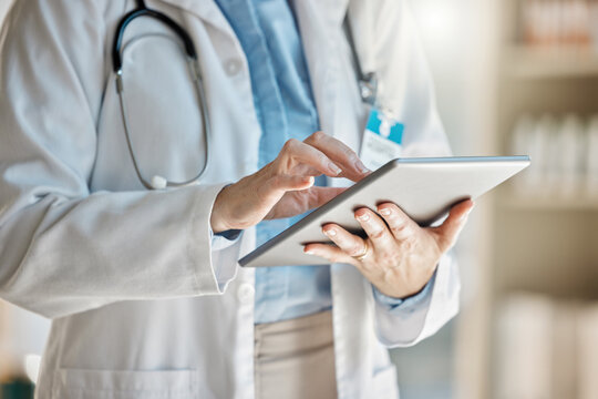 Doctor, office and tablet for research, email or communication. Medic, hospital and reading article, data or health magazine on web, while working with technology in healthcare center or clinic