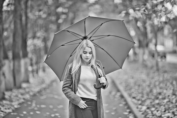Autumn umbrella girl in the park October walk in the rain