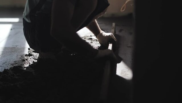 builder levels floors with sand