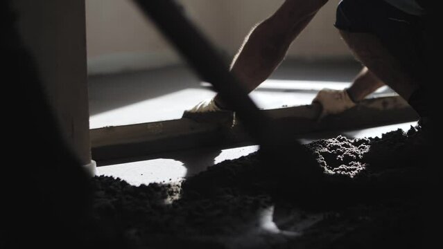 builder levels floors with sand