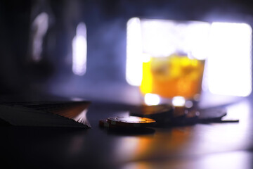 Gambling Card games for money. Texas Hold'em Poker. Cards in hand, playing chips, deck of cards of alcohol in a glass.
