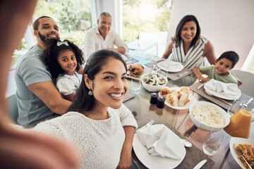 Fototapeta na wymiar Big family selfie while eating food or lunch together in their home dining room table with a portrait smile. Happy Puerto Rico parents, mother and father with children for digital holiday memory
