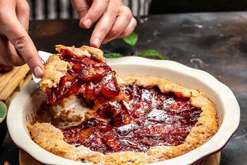 Plum Galette. Woman hands holds plum cake or pie. banner, menu, recipe place for text