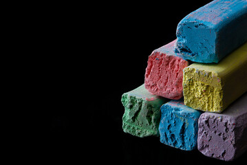 Colorful children's crayons on a black background.