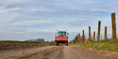 Tractor on country road after harvest