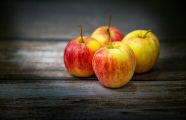 red apple on wood table in dark tone