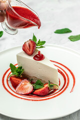 delicious homemade strawberry cheesecake with fresh strawberries, jam and mint