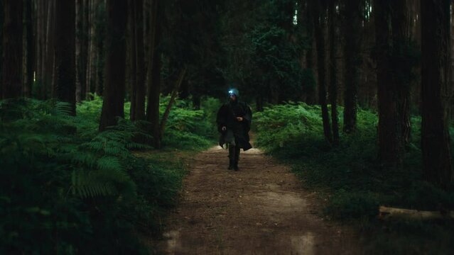 Military runs in a mountain road with light on his head