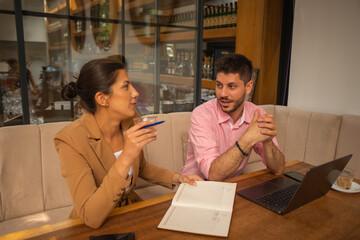 Male and female business people having a coffee time at cafeteria's terrace