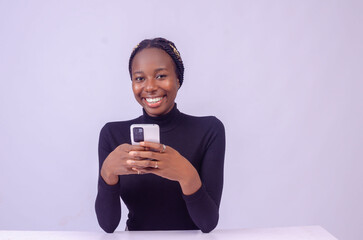 young black woman using her phone with a smiling