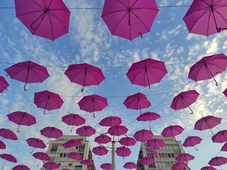 Fototapeta na wymiar Octobre rose, parapluies roses dans le ciel, Pau