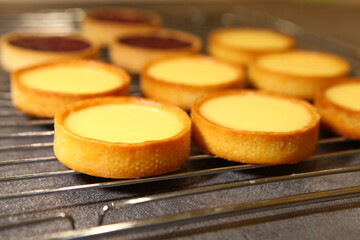 The tart cooking process, dessert in the oven, baking of tarts. Side view, top view. Professional dessert making process.