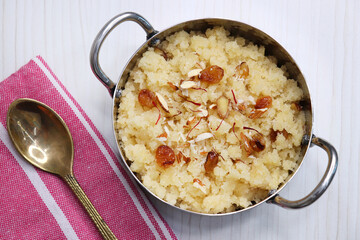 Rava Sheera or Suji ka halwa, shira is an indian sweet dish, made with semolina, sugar, ghee and dry fruits. served as dessert or as Prasad during festivals. Garnished with saffron. Copy space.