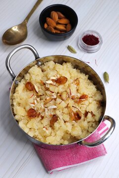 Rava Sheera or Suji ka halwa, shira is an indian sweet dish, made with semolina, sugar, ghee and dry fruits. served as dessert or as Prasad during festivals. Garnished with saffron. Copy space.