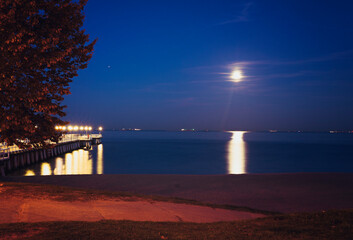 Landscape moon over the horizon on the sea and moonlight. Panorama with night moon. Reflection of...
