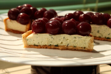 Tarts with cherry and white cream. Pie with meringue. Closeup view, tart cut, slice.