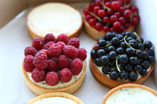 Tarts with raspberry, black currant and cream. Pie with meringue. Set of desserts. Set of tarts. Tart with beeries.